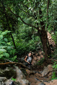Rear view of woman standing in forest