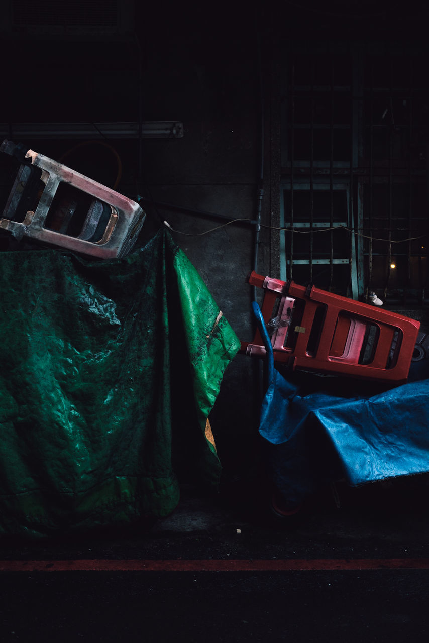 no people, night, transportation, mode of transportation, indoors, container, motor vehicle, car, still life, old, absence, abandoned, green color, dark, illuminated, nautical vessel, wall - building feature, table