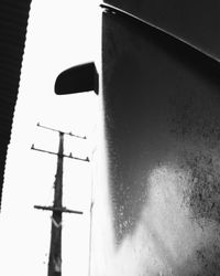 Low angle view of telephone pole against clear sky