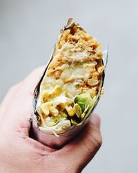 Close-up of cropped hand holding burrito