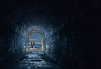 People standing at tunnel 