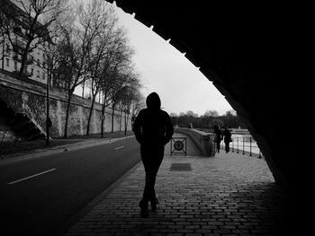 Rear view of silhouette people on bridge