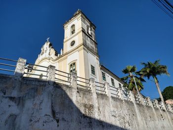 Low angle view of building against clear blue sky