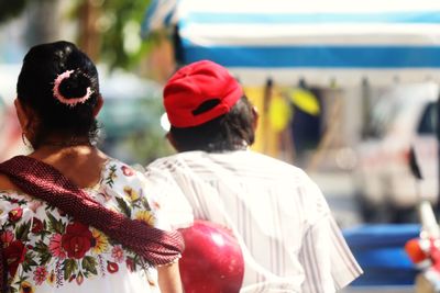 Rear view of friends against blurred background