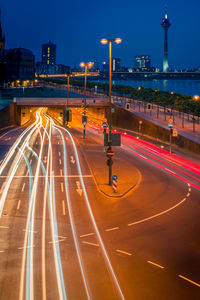 Light trails on road in city at night