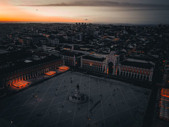 High angle view of illuminated city buildings during sunset