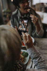 Midsection of man using mobile phone