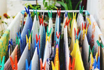 Close-up of multi colored flags hanging for sale