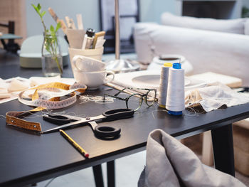 Scissor and thread spools on table