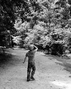 Full length of boy standing on tree