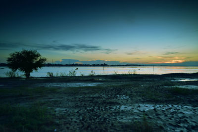 Scenic view of beach against sky during sunset