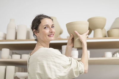 Owner working in pottery store