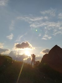 Man standing on field against sky