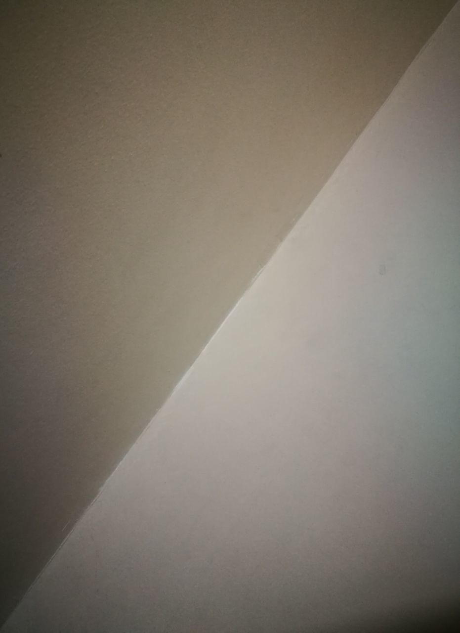 LOW ANGLE VIEW OF WALL WITH SHADOW