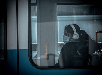 Man sitting on train window