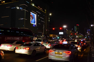 Cars on road in city at night