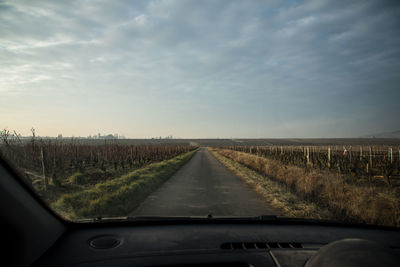 Road passing through landscape against sky