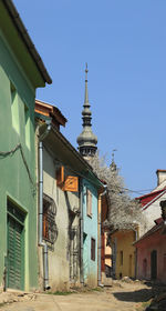 Low angle view of old building against clear blue sky