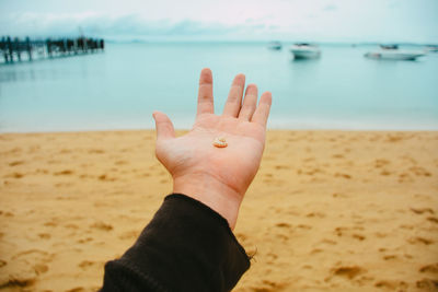 Midsection of person on beach