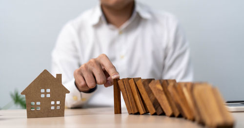 Midsection of woman playing with text on table
