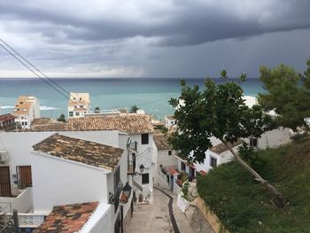 High angle view of buildings by sea against sky