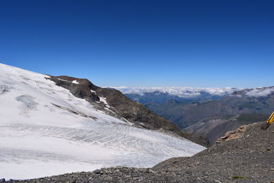 Scenic view of mountains against clear blue sky