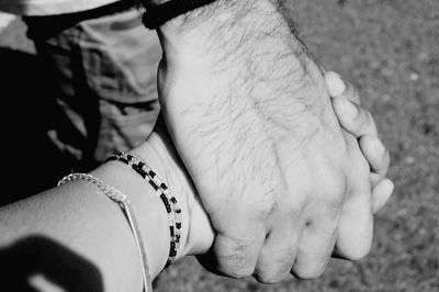 Close-up of couple holding hands