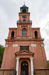 Low angle view of clock tower against sky