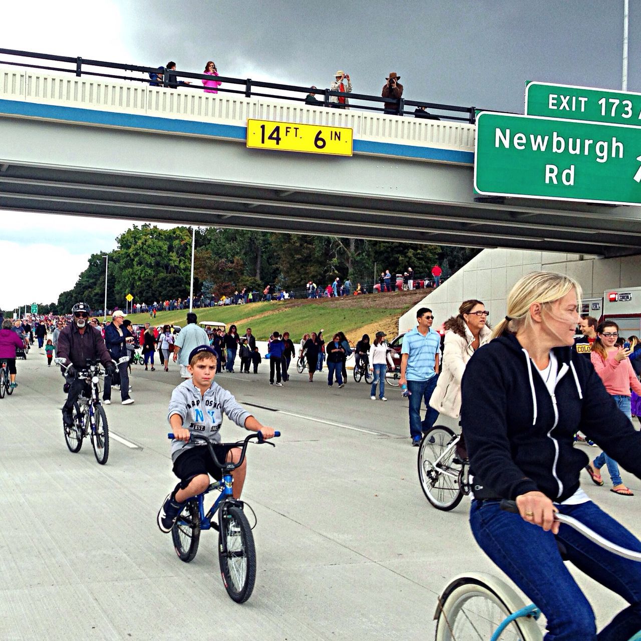 transportation, bicycle, men, land vehicle, mode of transport, large group of people, lifestyles, text, riding, person, street, leisure activity, western script, road, cycling, city life, city, travel, on the move