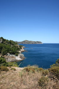 Scenic view of sea against clear blue sky