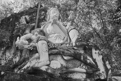 Statue against trees and plants