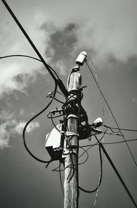 Low angle view of street light against cloudy sky