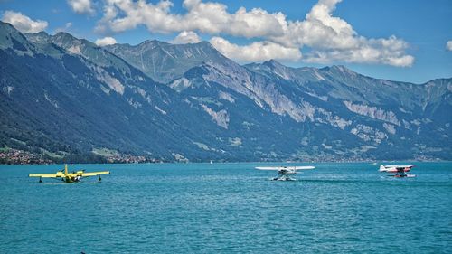 Scenic view of airplanes on water against cloudy sky