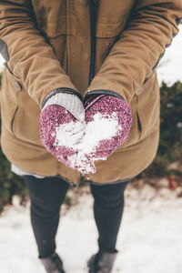 High angle view of woman holding snow