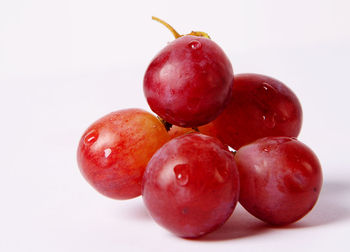 Close-up of cherries against white background