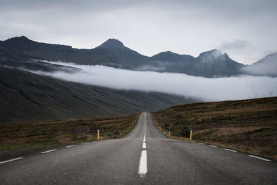 View of road on field against mountains