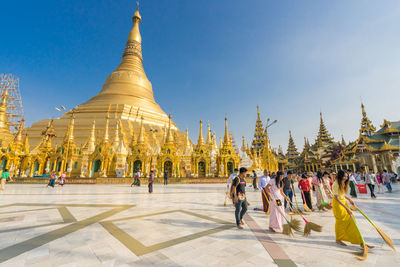 Group of people outside temple against building