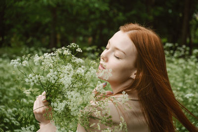 Healing power of nature, benefits of ecotherapy, nature impact wellbeing. happy redhead woman