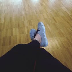 Low section of woman standing on tiled floor