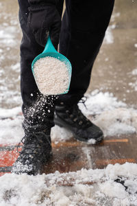 Low section of person standing on snow