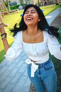 Portrait of a smiling young woman standing outdoors