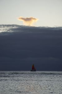 Sailboat sailing in sea against sky