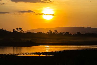 Scenic view of lake at sunset