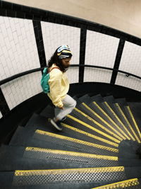 Full length of woman standing on steps