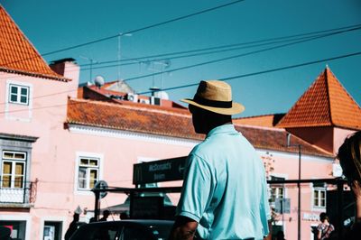 Midsection of man in city against sky