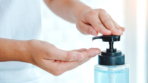 Close-up of human hand holding bottle