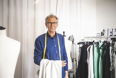 Portrait of male entrepreneur in clothing store