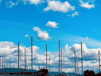 Low angle view of sailboats against blue sky
