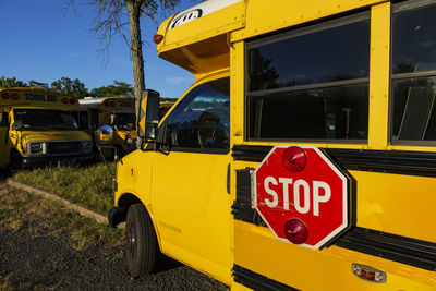 Yellow school bus against blue sky. stop sign on a side. school bus parking. back to school concept.