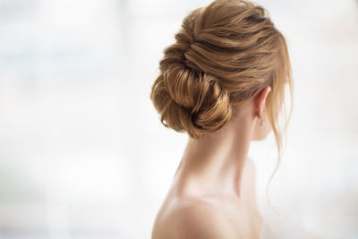 Young woman looking away against white background